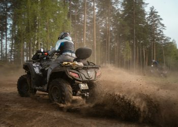 a person riding an atv on a dirt road