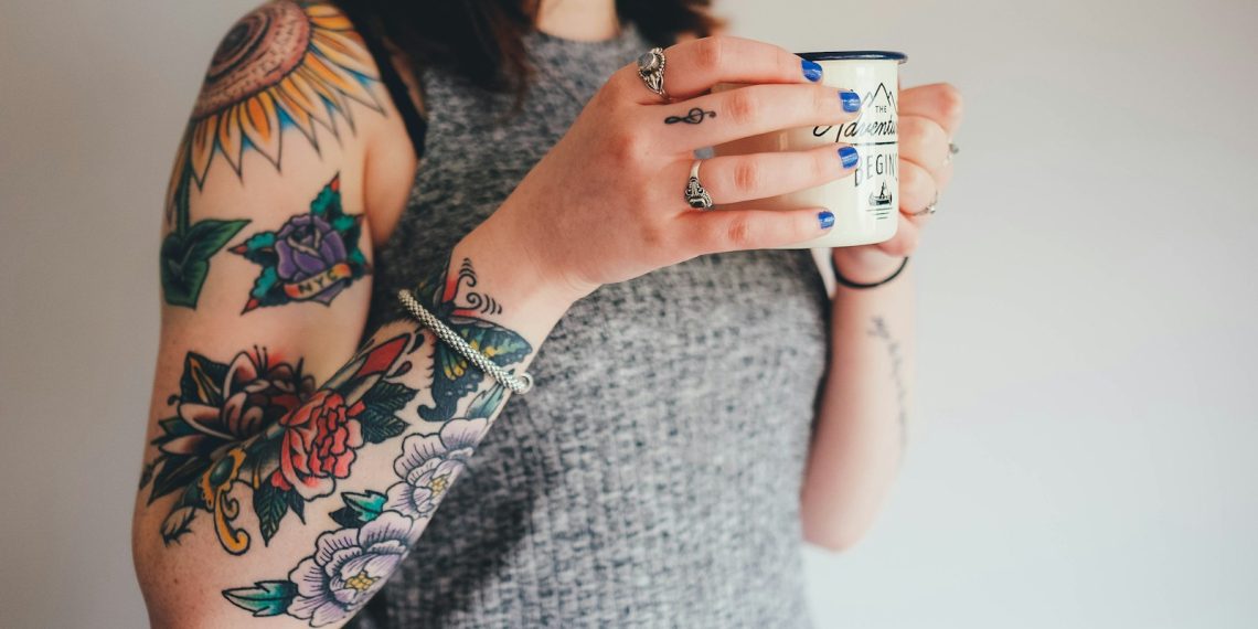 woman holding white ceramic mug