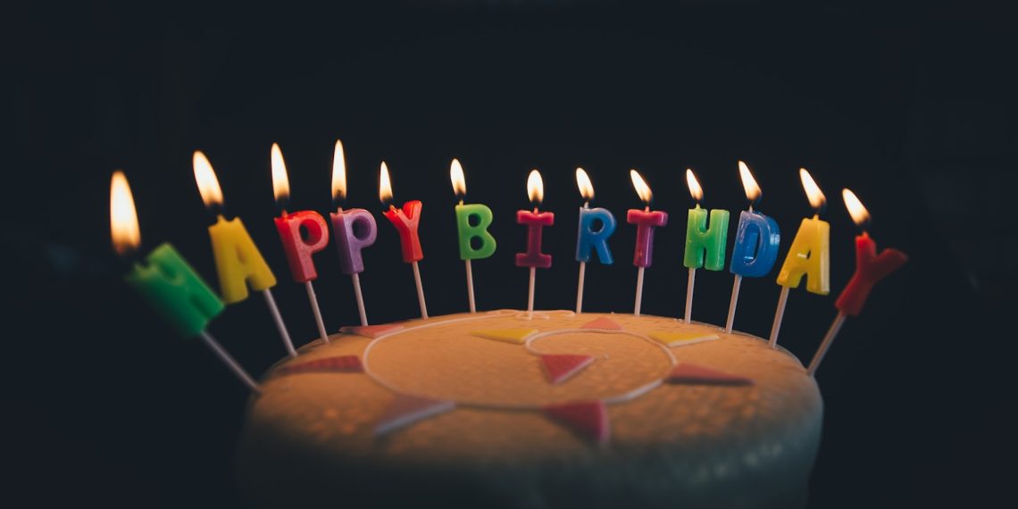 round fondant cake with happy birthday candle